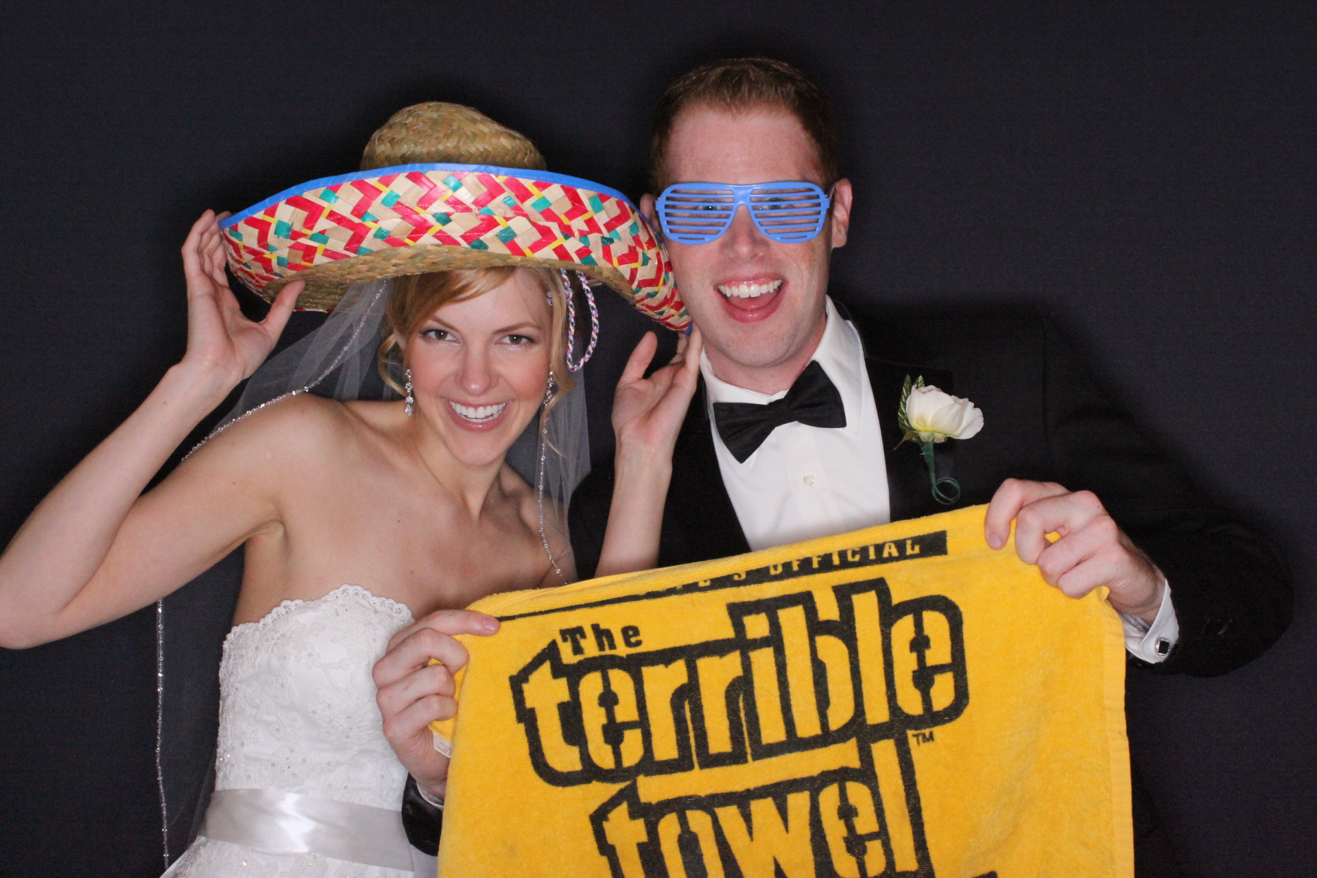 Bride and groom in the All-Stars photo booth with a Terrible Towel